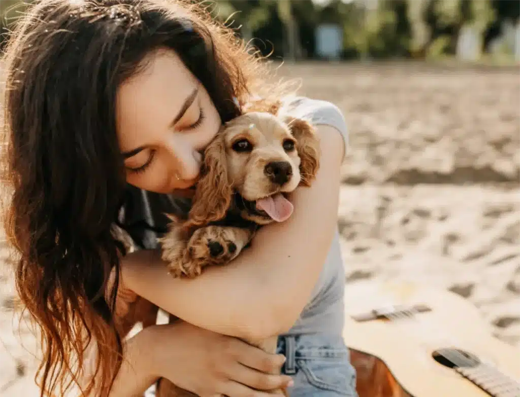 Woman cuddling puppy survival guide to care for your new puppy