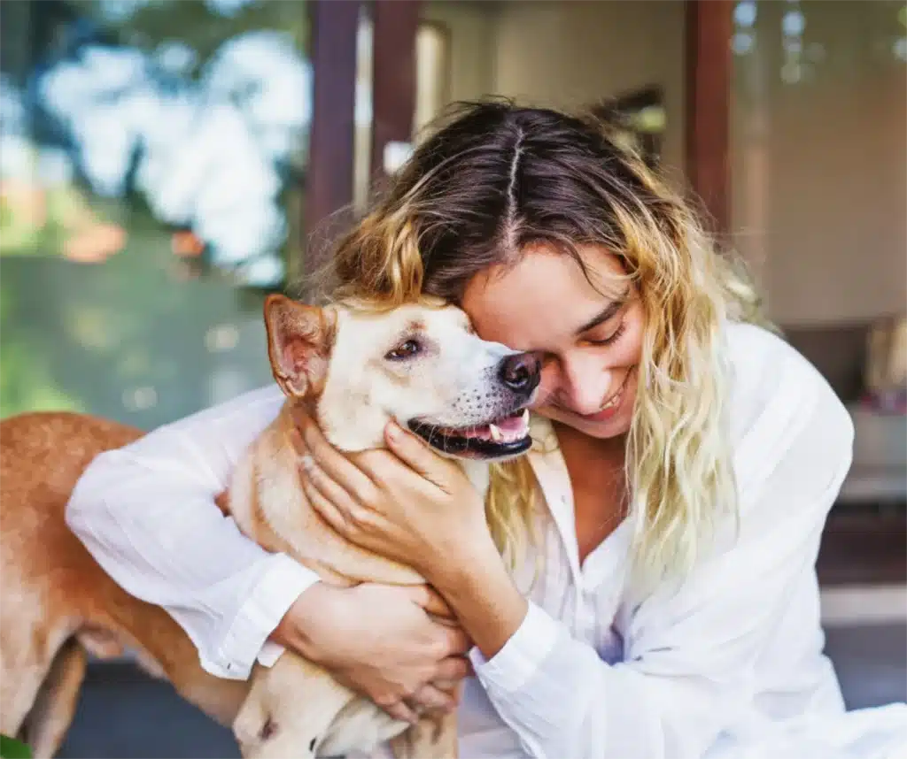 Pets and Well being - woman holding her dog