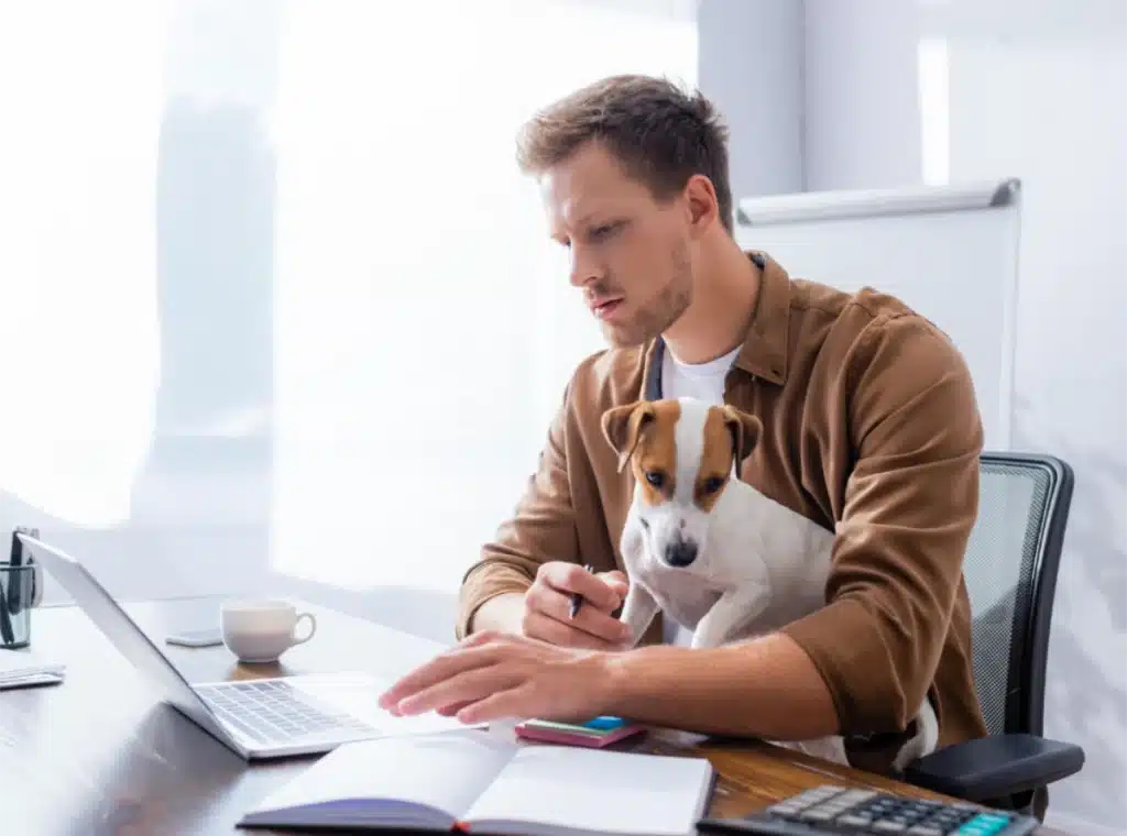 Cost of Living man with dog doing his accounts